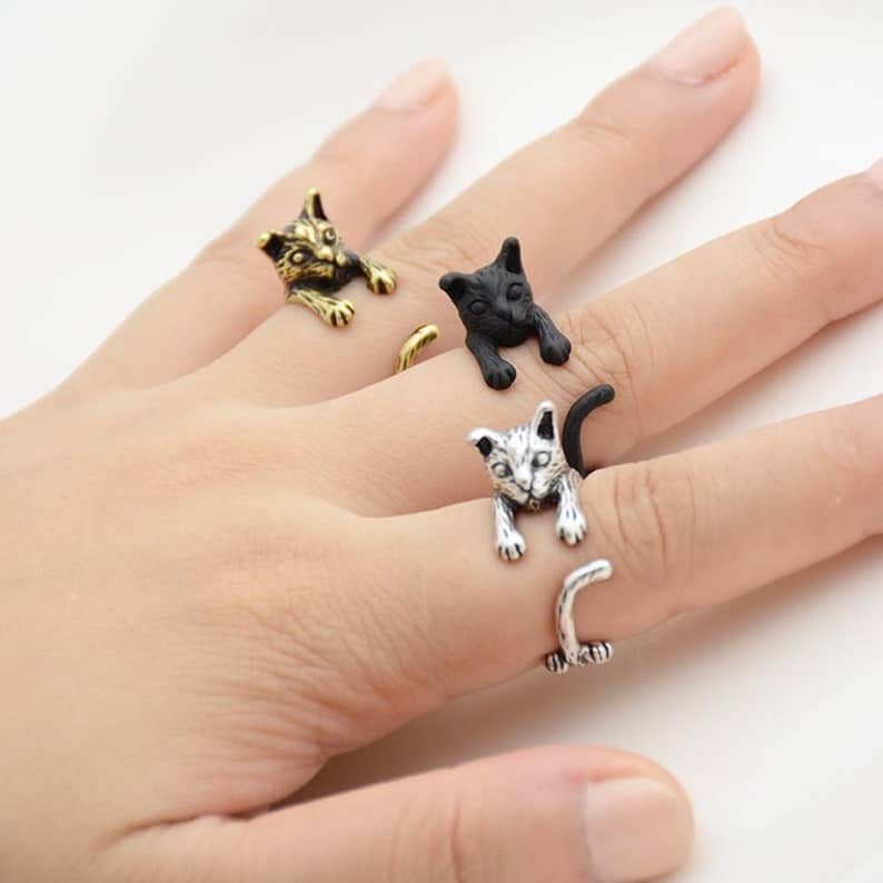 Three adjustable cat rings on different fingers