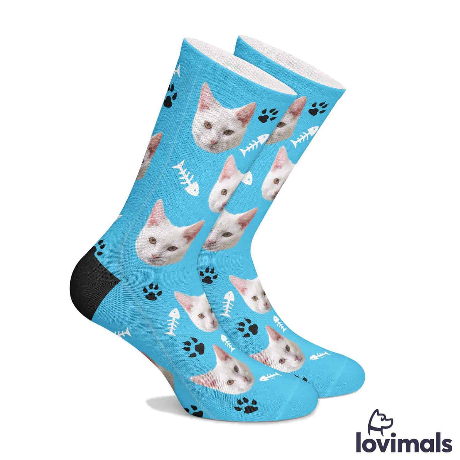 Blue socks with cats heads, paw prints, and fish bones