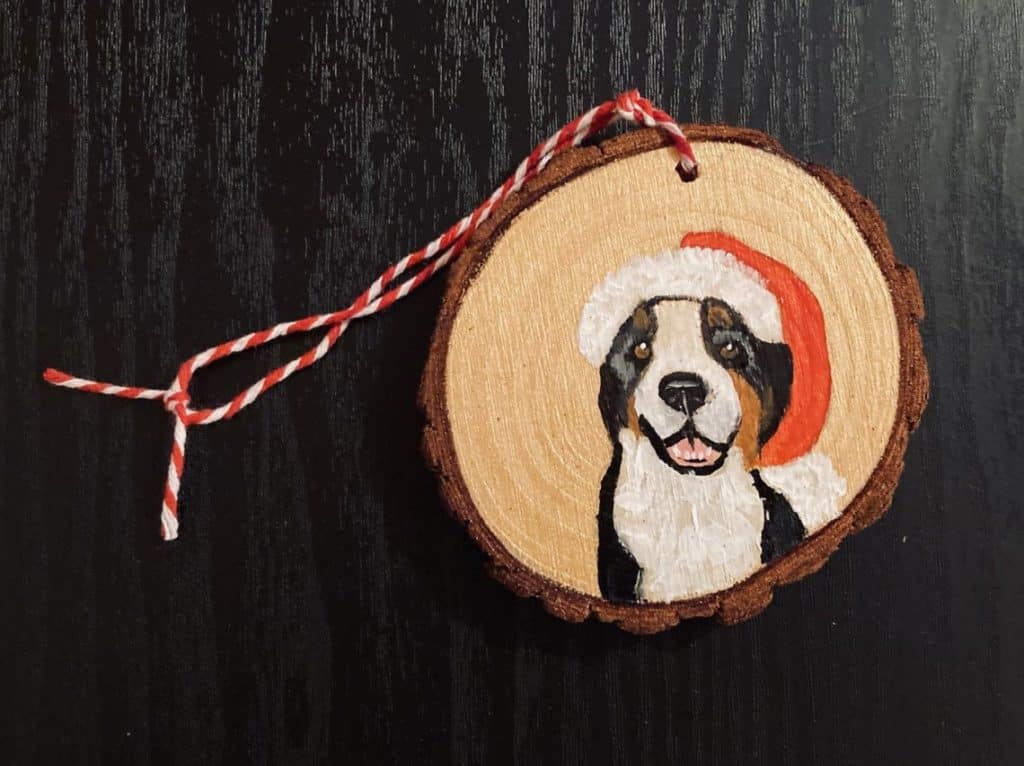 Hand painted dog on round wooden ornament